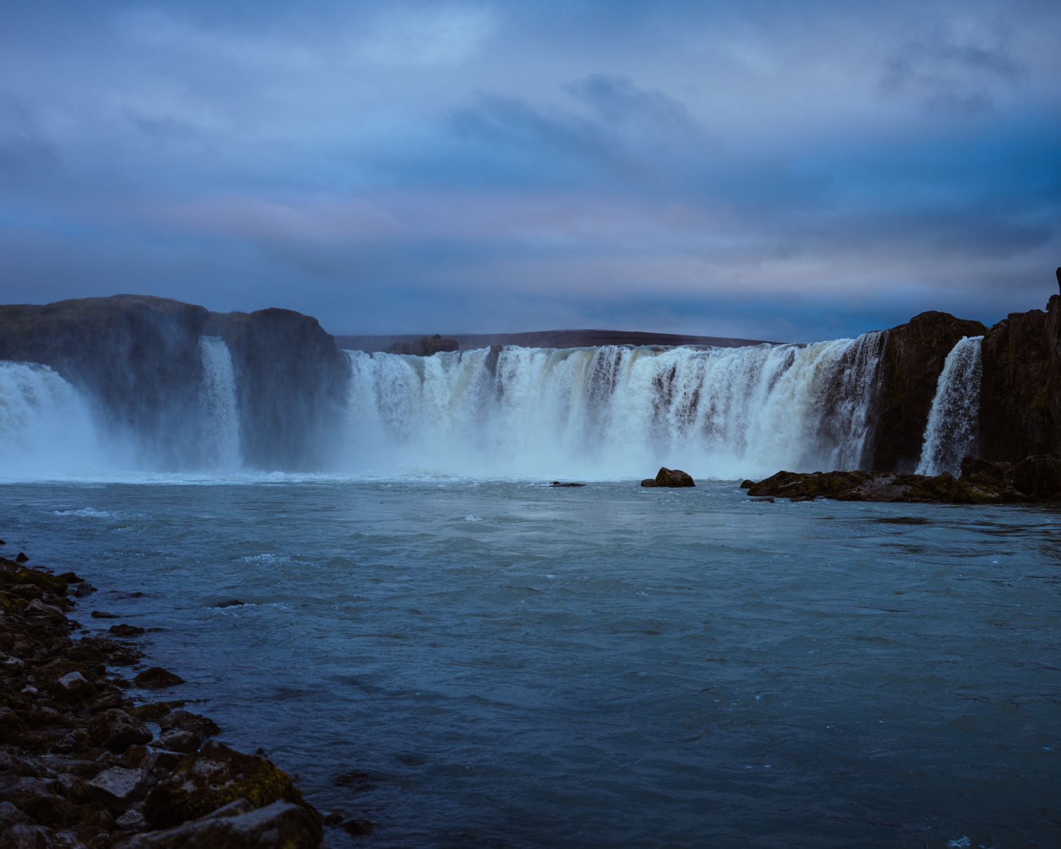 Goðafoss under an overcast northern sky.