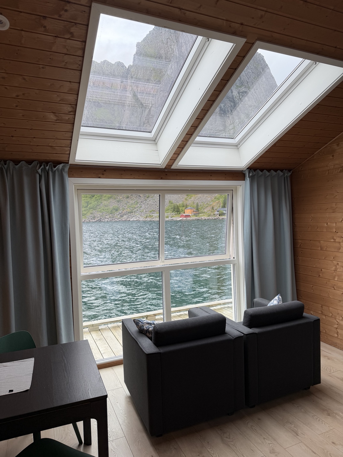 The chairs, large windows, and skylights in my cabin at Eliassen Rorbuer.